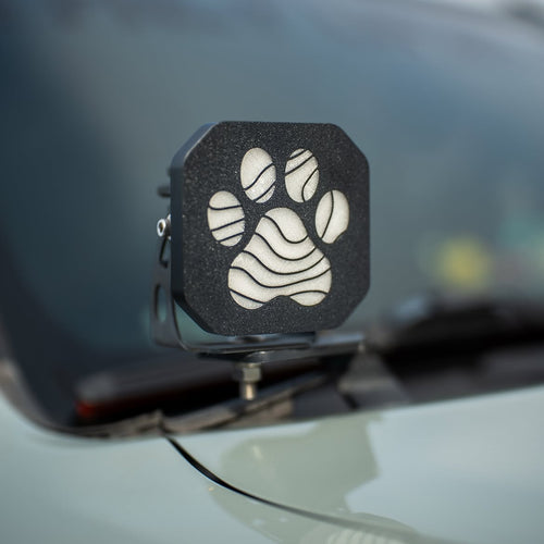 Custom paw print cover on a Diode Dynamics pod light mounted on a white truck